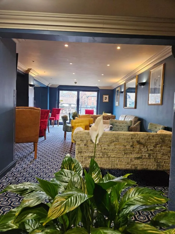 Living room with sofas and a table in the Victoria Cloisters Apartments in York