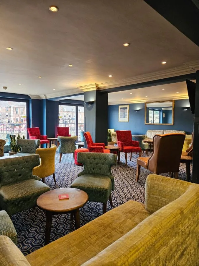 Waiting room with colourful chairs and tables at The Queens Hotel & Victoria Cloisters Apartments in York