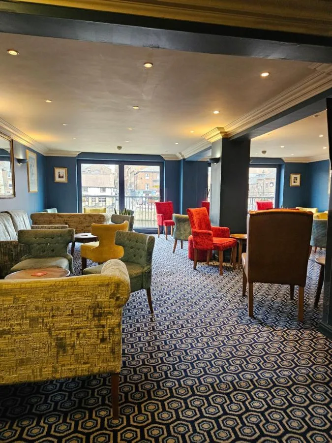 Waiting room with sofas and tables and chairs at The Queens Hotel & Victoria Cloisters Apartments in York